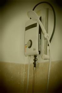 a shower head is attached to a wall with a hose at Ana's Bungalow in Siquijor +53 photos