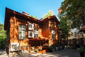 an old brick building with windows and tables and chairs at Ruby Red House in Sofia