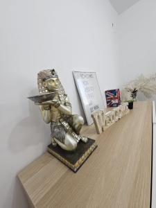 a metal statue of a samurai on a shelf at Central Mood Apartment Heart of Bucharest in Bucharest