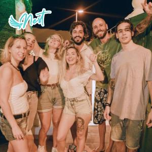 a group of young people posing for a picture at Arena Nest Hostel in Puerto de Santiago