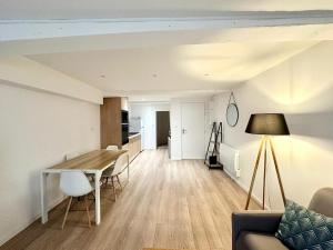 a living room and kitchen with a table and chairs at Appartement Cosy au coeur de Crémieu in Crémieu
