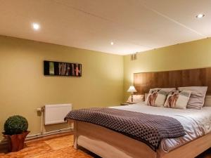 a bedroom with a large bed in a room at La Belle vue in Durbuy