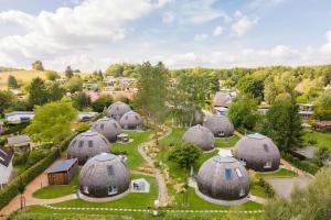 an aerial view of a village with domes at Kugelhaus Nordlichter - Skandinavischer Rückzugsort in runder Form am Tollensesee in Wustrow
