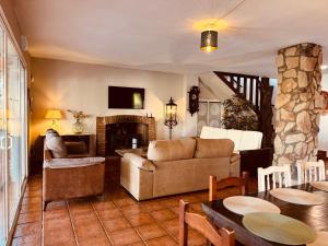 a living room with a couch and a fireplace at Casa Rural Cornalvo in Mirandilla