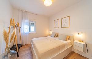 a white bedroom with a bed and a window at Holiday house VIRA by Villas Guide in Blato +38 photos