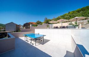 a blue ping pong table on a patio at Holiday house VIRA by Villas Guide in Blato