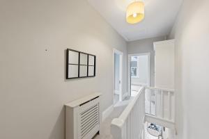 a white staircase in a home with white walls at modern 4 bdr house rock ave in Gillingham