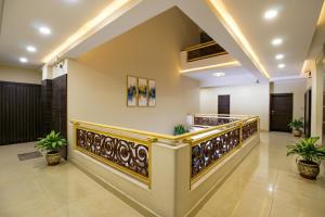 a lobby with a staircase in a building at FabHotel Kamla Regency in Bhopal