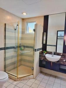 a bathroom with a shower and a sink at Seri Suites KLcc in Kuala Lumpur