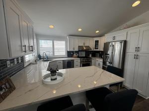 a kitchen with white cabinets and a large counter top at Wifi Decks Private Yard Beach Badges Beach Chairs Keurig Os Wd 3Rd Off The Beach in Brant Beach