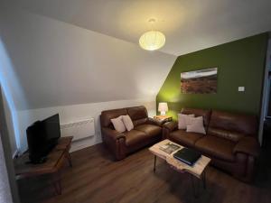 a living room with a couch and a tv at Glenlude - Uk50493 in Kylestrome