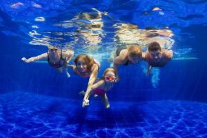 a group of girls swimming in a swimming pool at Lovely 6 Berth Caravan With Decking At California Cliffs In Scratby Ref 50048L in Great Yarmouth