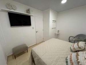 a bedroom with a bed and a flat screen tv at Don Antonio Apart 2 in Resistencia