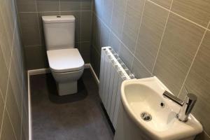 a small bathroom with a toilet and a sink at Cottage - Sleeps 4 - Pets Ok - Garden - Parking in Keswick