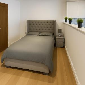 a bedroom with a bed in a white room at Rentals Leicester 8 - Free St Parking in Leicester