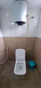 a small bathroom with a toilet and a sink at A J Home Stay in Tiruvannāmalai