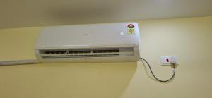 a toaster is plugged into a wall in a room at A J Home Stay in Tiruvannāmalai +11 photos