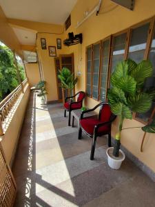 a hallway with chairs and plants in a building at CityStays by Rajat in Jaipur