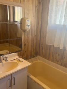 a bathroom with a sink and a bath tub at Cozy Queen Room Next to Station and Shops - PH6 in Pendle Hills