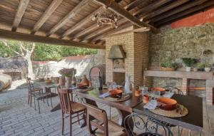 an outdoor patio with tables and chairs and a fireplace at Holiday Home Montefiascone 96 With Outdoor Swimmingpool in Ranucci