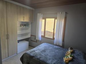 a bedroom with a bed and a window at Sítio meu recanto in Paulo Lopes