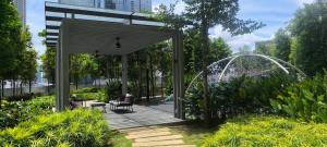 a pavilion in a garden with a bench at Service Apartment Agile Residence KL in Kuala Lumpur
