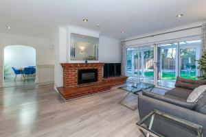 a living room with a couch and a fireplace at Windsor Reach in Datchet