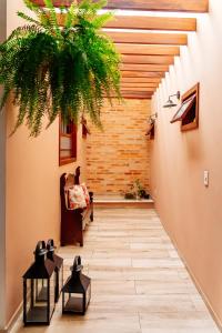 a hallway of a building with a plant at Vila de Cunha in Cunha