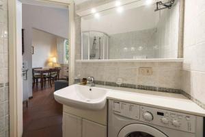 a bathroom with a sink and a washing machine at Borgo Allegri Palace By MMega in Florence +53 photos