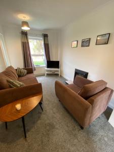 a living room with two couches and a table at Riverside walk in Newark upon Trent