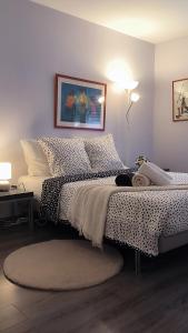 a bedroom with a bed with polka dot sheets at Port Royal in Aix-en-Provence