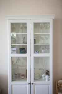a white cabinet with wine glasses in it at Apartments Sand Beach in Split