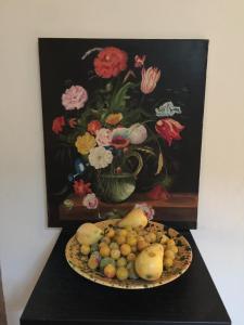 a painting of a vase of flowers with a plate of fruit at L'étape Impressionniste in Croissy-sur-Seine +18 photos