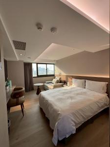 Ένα ή περισσότερα κρεβάτια σε δωμάτιο στο Fooyee Hotel Taichung Yizhong