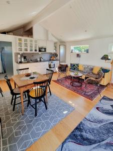 a living room with a table and chairs and a kitchen at Modern Guest House Near The Sea In Brösarp in Brösarp