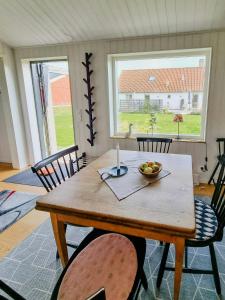 a wooden table with a bowl of fruit on it at Modern Guest House Near The Sea In Brösarp in Brösarp +5 photos