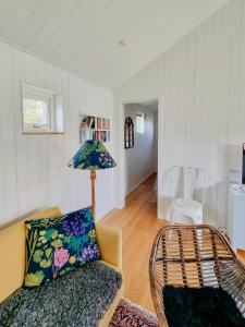 a living room with a couch and a lamp at Modern Guest House Near The Sea In Brösarp in Brösarp