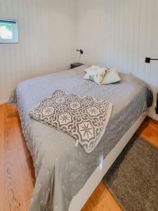 a bedroom with a bed with a blanket on it at Modern Guest House Near The Sea In Brösarp in Brösarp