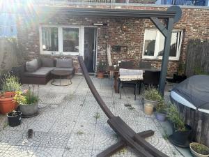 a patio with a gazebo and a table and chairs at Casa Pelzerro in Aachen
