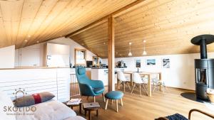 a kitchen and living room with a couch and a table at Soldanella Chalet, Riederalp Golmenegg in Riederalp