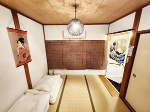 a small room with a couch and a window at D,A-House OSAKA in Osaka