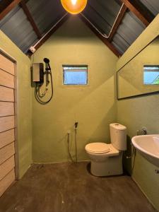 a bathroom with a toilet and a sink at eagleye glamping langkawi in Pantai Kok