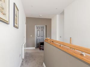 an empty hallway with a staircase in a house at Formans Lodge in Musselburgh