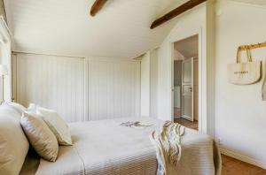 a bedroom with a bed with white sheets and pillows at Relaxing Villa With Fireplace And Private Stream in Lerdala