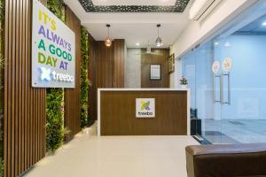 a lobby of a hospital with a sign that reads it is always a good day at Treebo RKH Palace in Chennai