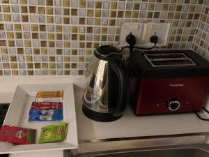 a toaster sitting on top of a kitchen counter at Modern 1 bedroom apartments in DHA in Lahore +2 photos