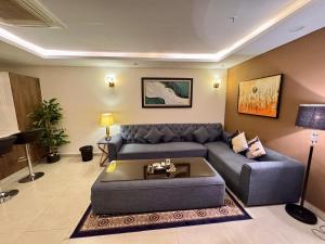 a living room with a couch and a table at Modern 1 bedroom apartments in DHA in Lahore