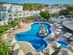 an aerial view of a resort pool with umbrellas at Royal Nozha in Hammamet