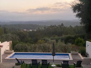 a villa with a swimming pool and chairs at Casa do Vale Vintém in Condeixa a Nova