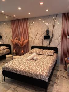a bedroom with a bed and a stone wall at L'Écrin Secret Romantic Love Room & Private Spa in Ambilly